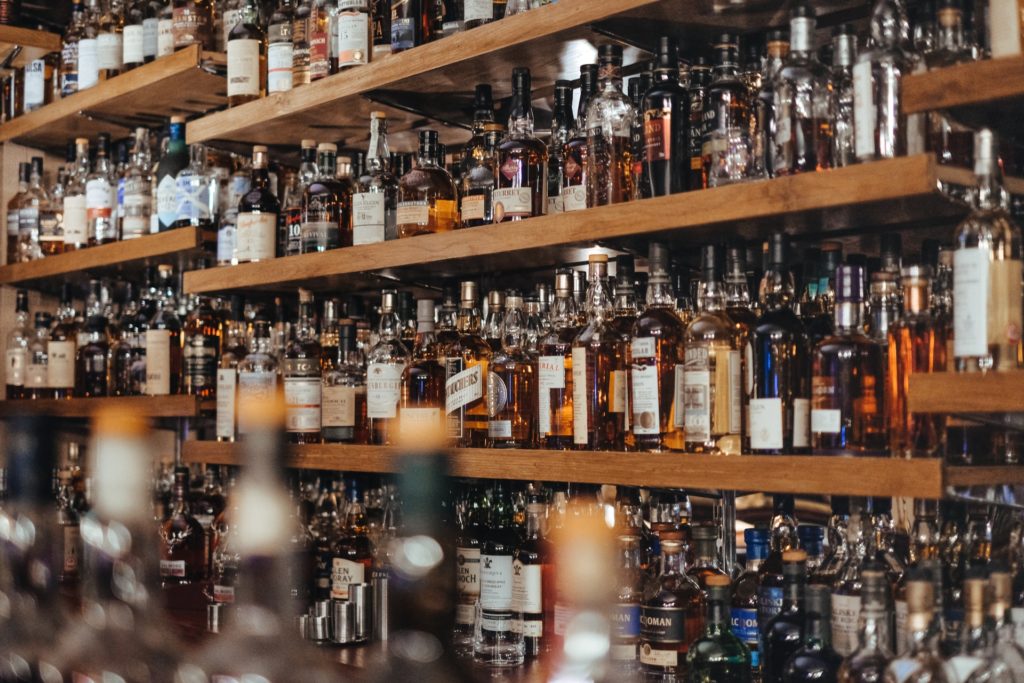 Shelves of liquor in a bar representing a bar promoter found guilty for sexual assault