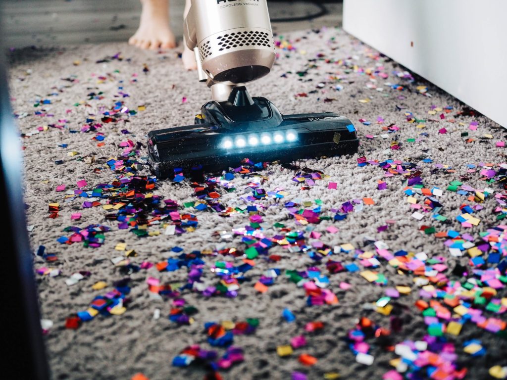vaccum cleaner cleaning up confetti