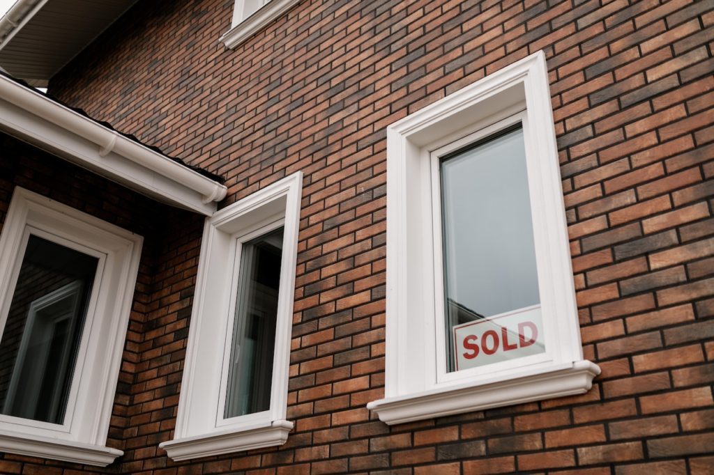 a window with sold sign