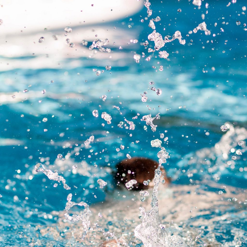 person diving in pool