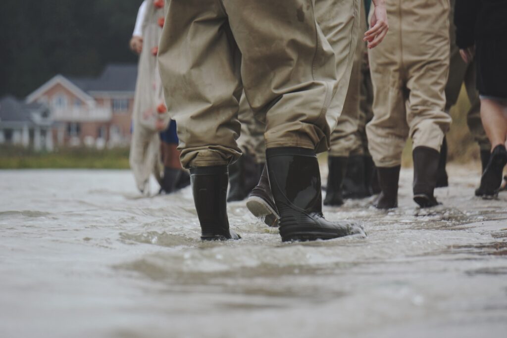 black rubber boots in flood waters